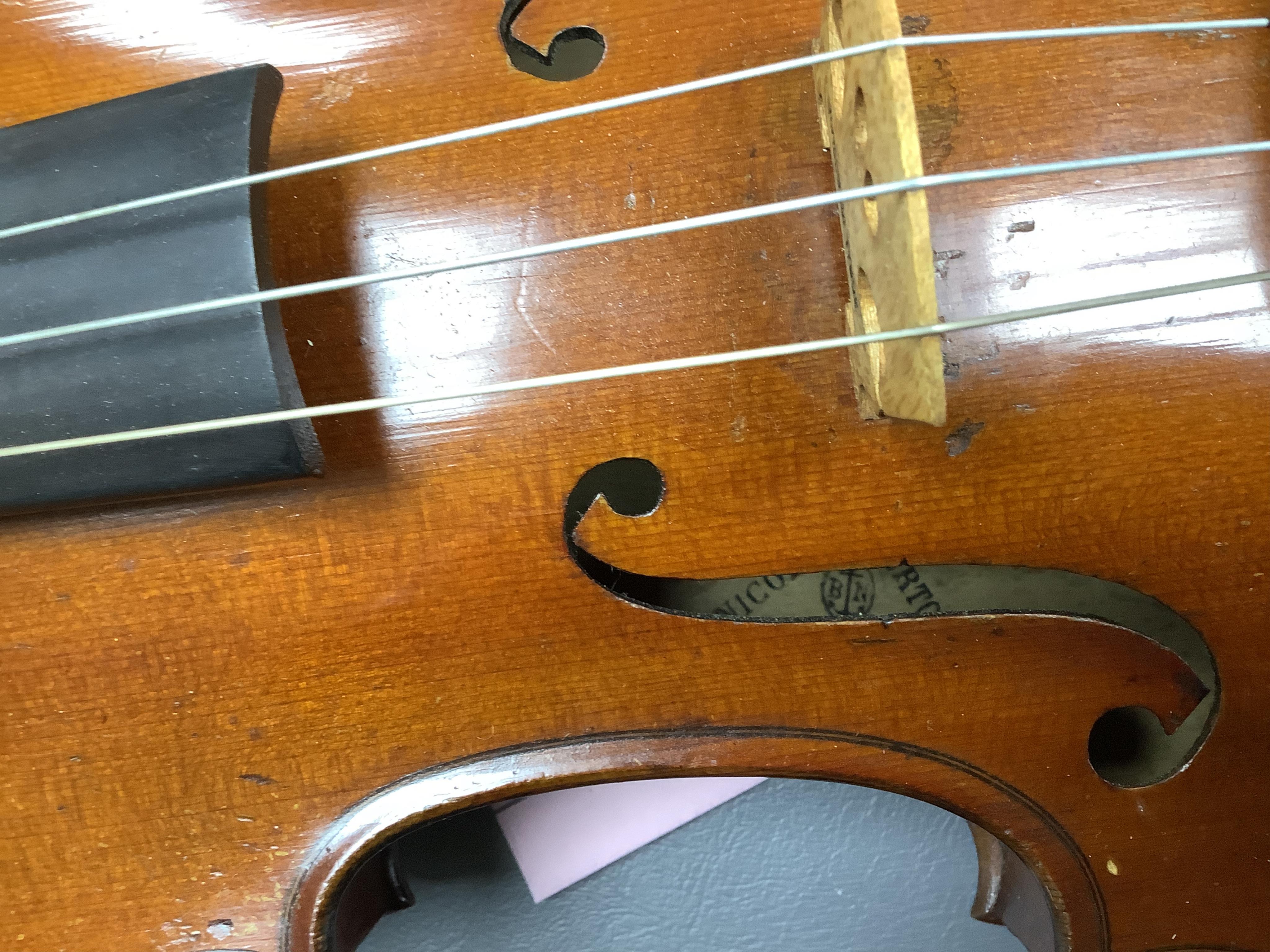 A cased late 19th century violin, signed ‘Nicolas Bertolini’, back 36.3cm, with bow stamped Paesold, CITES Submission reference, D9GSYMLJ